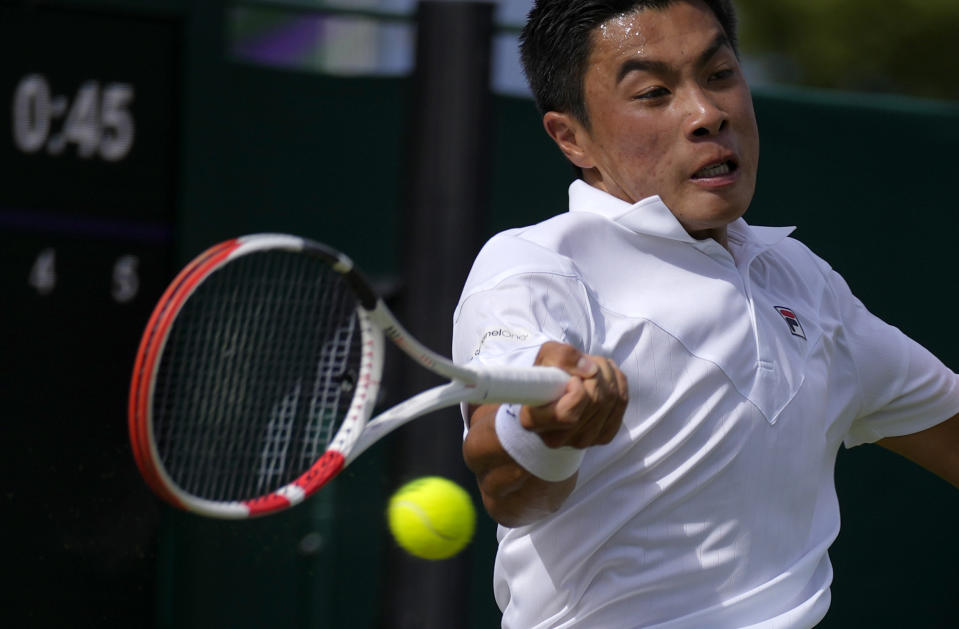 Brandon Nakashima of the US returns to Canada's Denis Shapovalov in a second round men's single match on day four of the Wimbledon tennis championships in London, Thursday, June 30, 2022. (AP Photo/Alastair Grant)