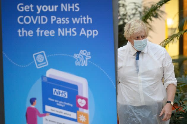 &lt;strong&gt;Boris Johnson walks past a poster advertising the NHS Covid Pass during a visit to a vaccination centre in Ramsgate, Kent.&lt;/strong&gt; (Photo: Leon Neal via PA Wire/PA Images)