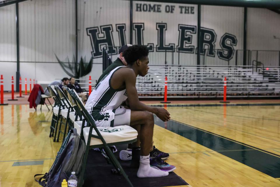 Tower Hill guard Dean Shepherd (12) sits on the bench after a DIAA quarterfinals game between Tower Hill and Salesianum Saturday.