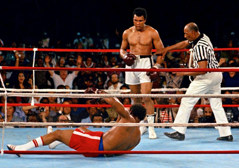 Muhammad Ali knocked down defending heavyweight champion George Foreman in the eighth round of their championship bout on Oct. 30, 1974, in Kinshasa, Zaire.