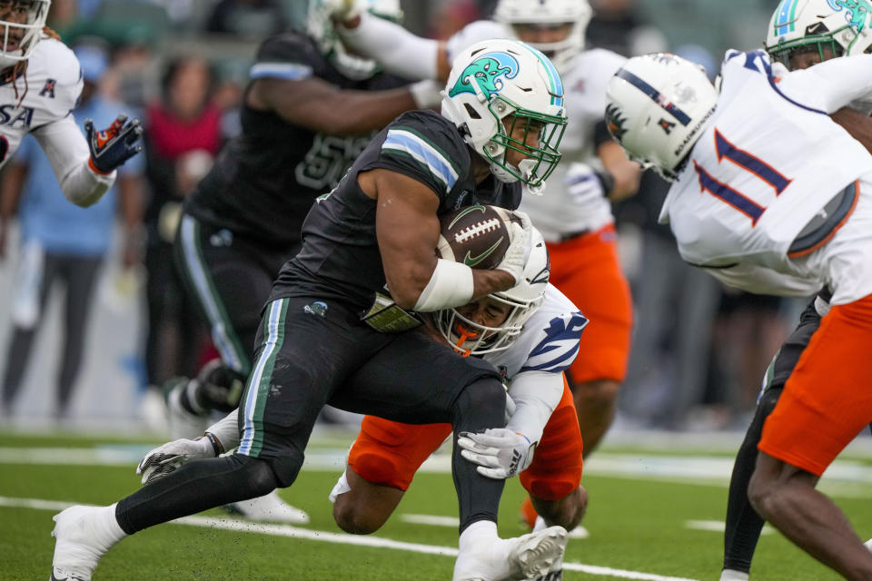 Tulane running back Makhi Hughes (21) carries in the first half of an NCAA college football game against UTSA in New Orleans, Friday, Nov. 24, 2023. (AP Photo/Gerald Herbert)