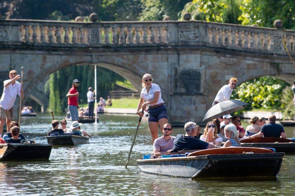 People punt along the River Cam in Cambridge as the heatwave continues throughout the long weekend. (PA)