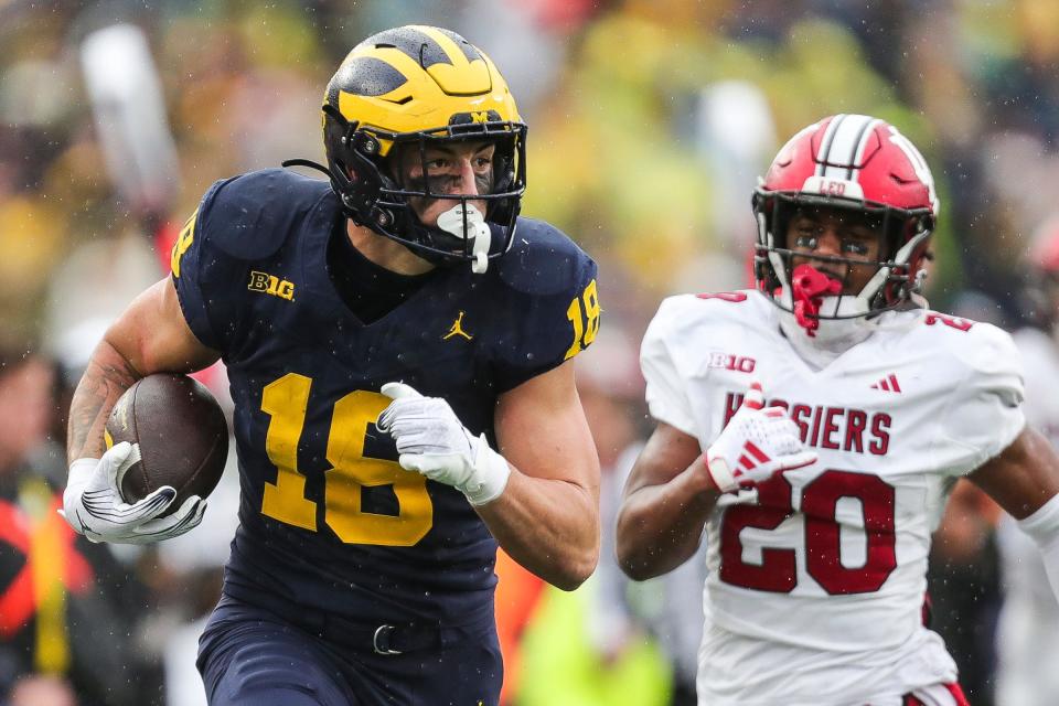 Michigan tight end Colston Loveland runs against Indiana defensive back Louis Moore during the second half of U-M's 52-7 win over Indiana on Saturday, Oct. 14, 2023, in Ann Arbor.