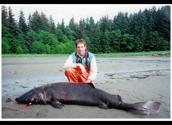 This 2000 image shows biologist Bruce Wright in salt waters in southeast Alaska with a small Pacific sleeper shark that was caught on a research cruise. He believes much bigger versions of this shark group could be the true identity of Scotland's Loch Ness Monster and Alaska's Lake Iliamna creature known as Illie.