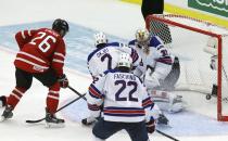 Canada's Curtis Lazar (L) scores on United States' goalie Jon Gillies (R) during the third period of their IIHF World Junior Championship ice hockey game in Malmo, Sweden, December 31, 2013. REUTERS/Alexander Demianchuk (SWEDEN - Tags: SPORT ICE HOCKEY)