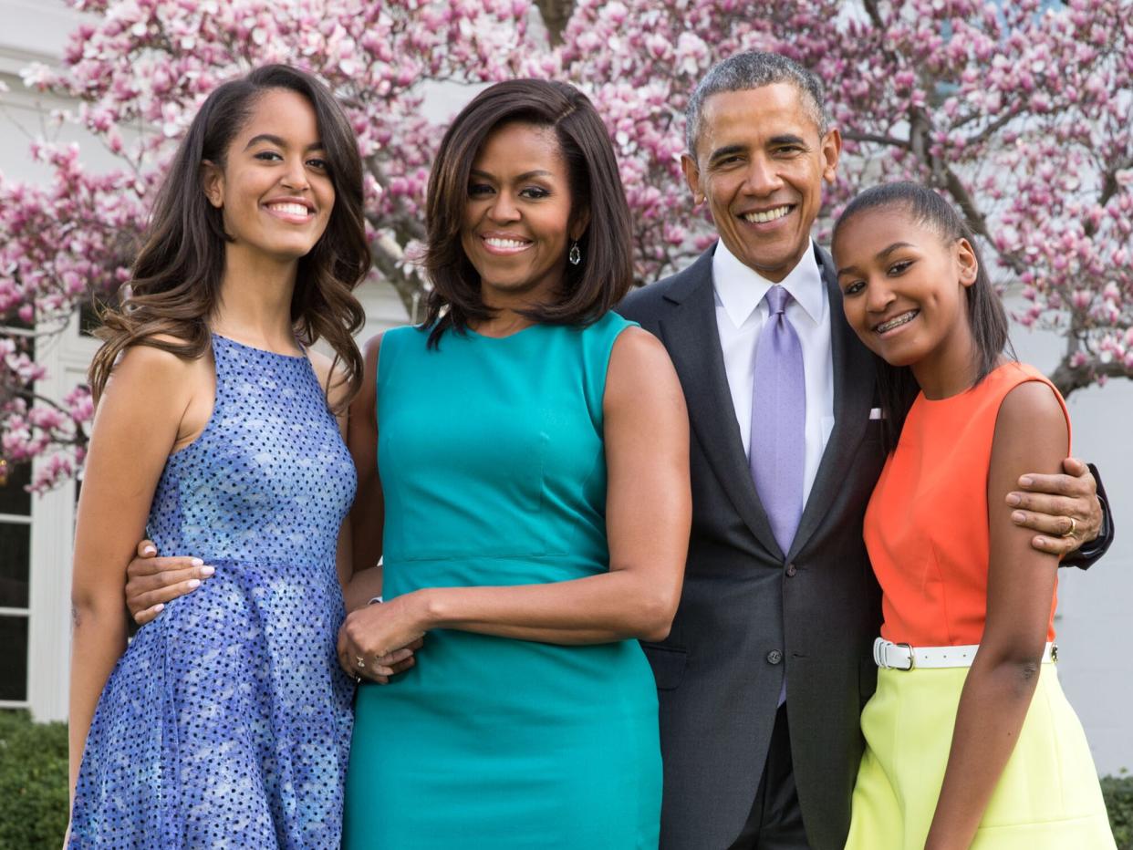 Barack Obama, Michelle Obama, and daughters Malia (L) and Sasha (R) pose for a family portrait in the Rose Garden of the White House on Easter Sunday, April 5, 2015 in Washington, DC