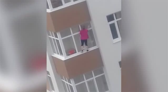 The woman appears confident while she washes the windows. Source: Viralhog