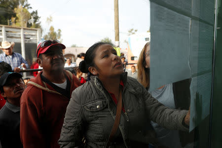 Residents check the list of people injured during the explosion of a fuel pipeline ruptured by suspected oil thieves, in the municipality of Tlahuelilpan, state of Hidalgo, Mexico January 19, 2019. REUTERS/Henry Romero