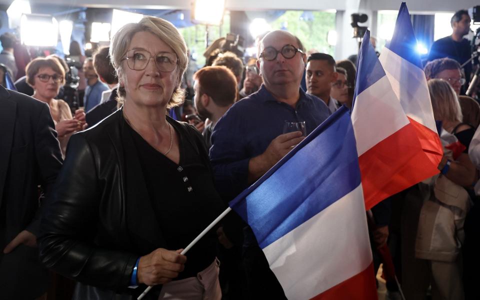 National Rally supporters await the results before the exit polls were announced