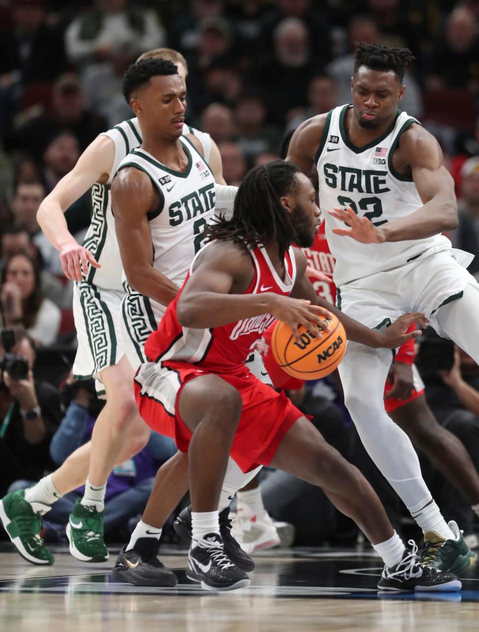 Michigan State Spartans guard Tyson Walker (2) and  center Mady Sissoko (22) defend against Ohio State Buckeyes guard Bruce Thornton (2) during second-half action in the Big Ten tournament quarterfinals at United Center in Chicago on Friday, March 10, 2023.