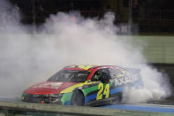 William Byron does doughnuts as he celebrates after winning a NASCAR Cup Series auto race, Sunday, Feb. 28, 2021, in Homestead, Fla. (AP Photo/Wilfredo Lee)