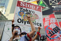 <p>People protest against the hosting of the Tokyo 2020 Olympic Games in Tokyo on July 23, 2021. (Photo by Philip FONG / AFP) (Photo by PHILIP FONG/AFP via Getty Images)</p> 