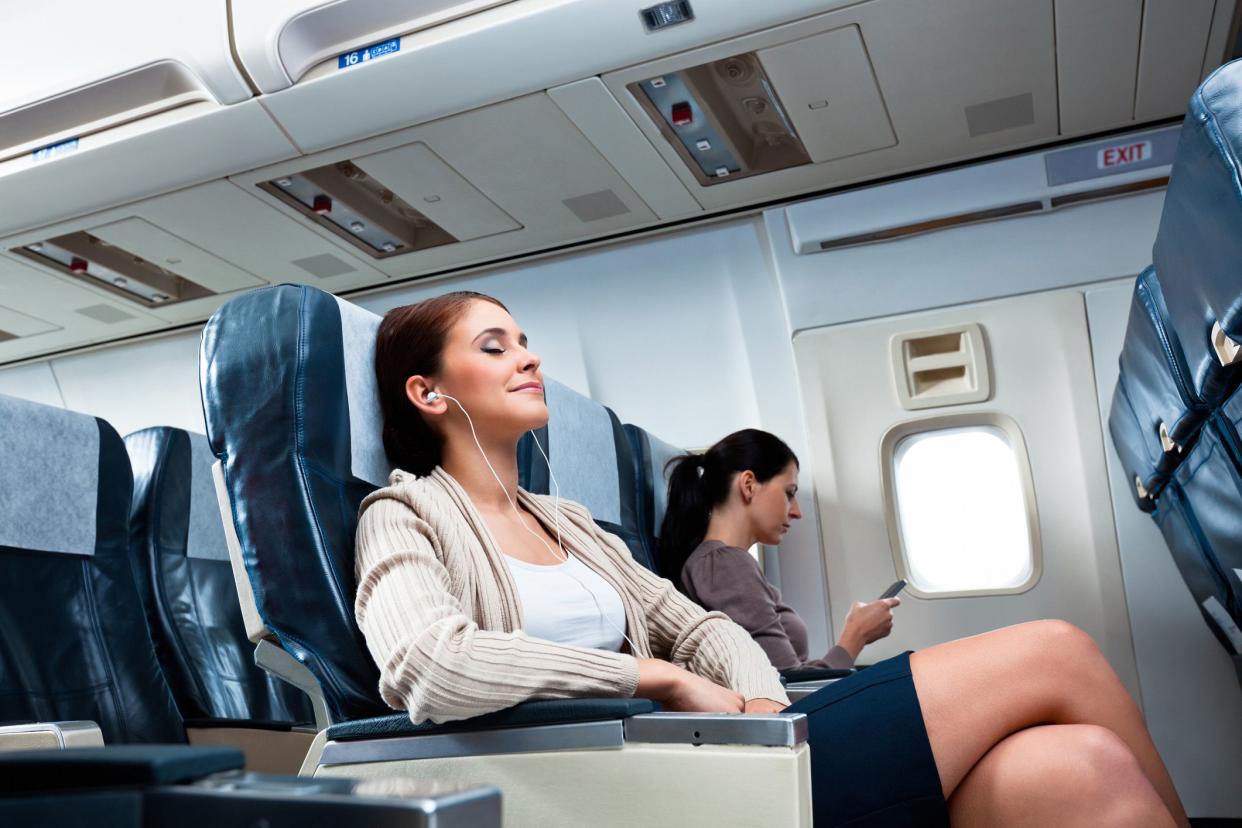 relaxed woman smiling on plane