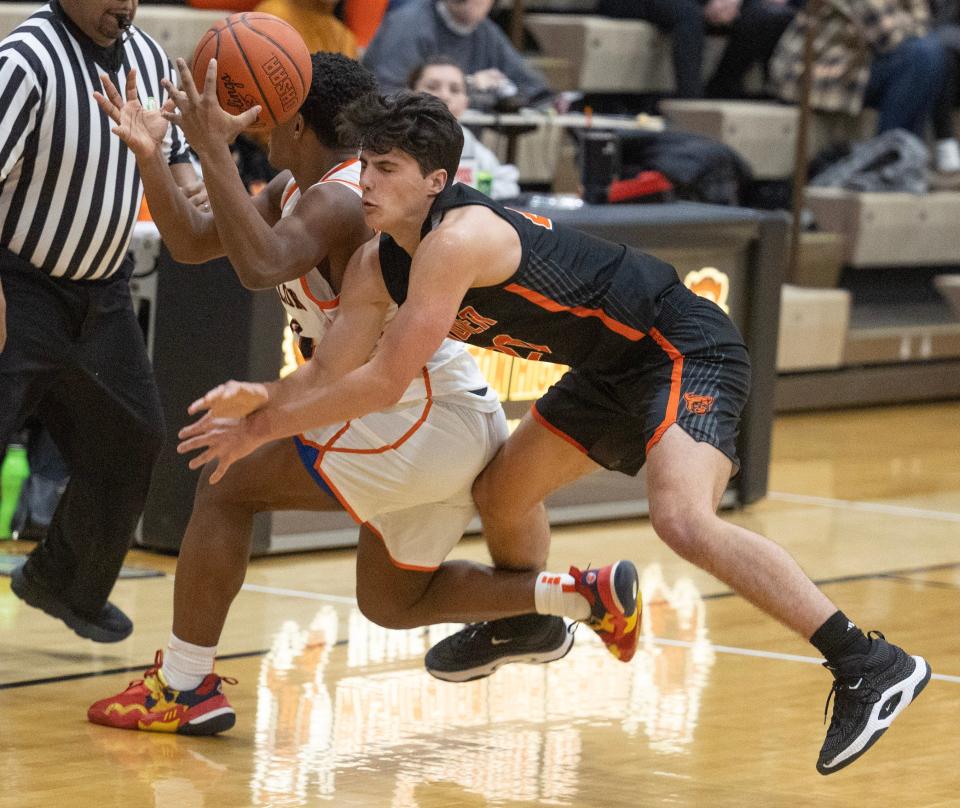 Hoover's Logan Ash (right) collides with Massillon's Xavier Williams at midcourt in the second half.