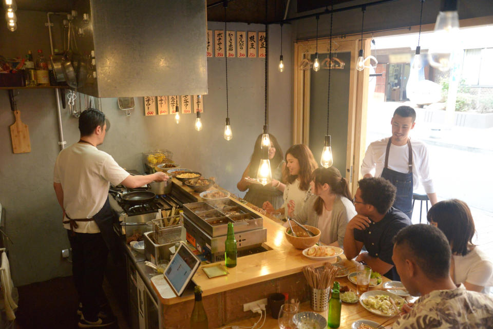 People sitting at restaurant chef's counter