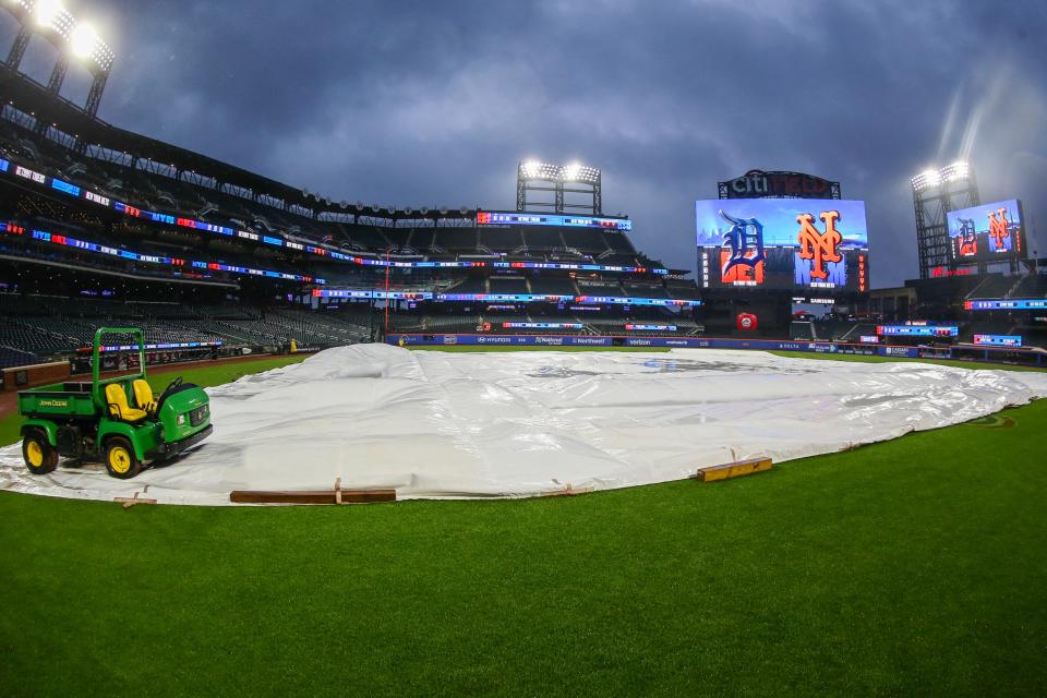 The tarp is placed on the field prior to the start of the game between the Detroit Tigers and the New York Mets on April 2, 2024, at Citi Field.