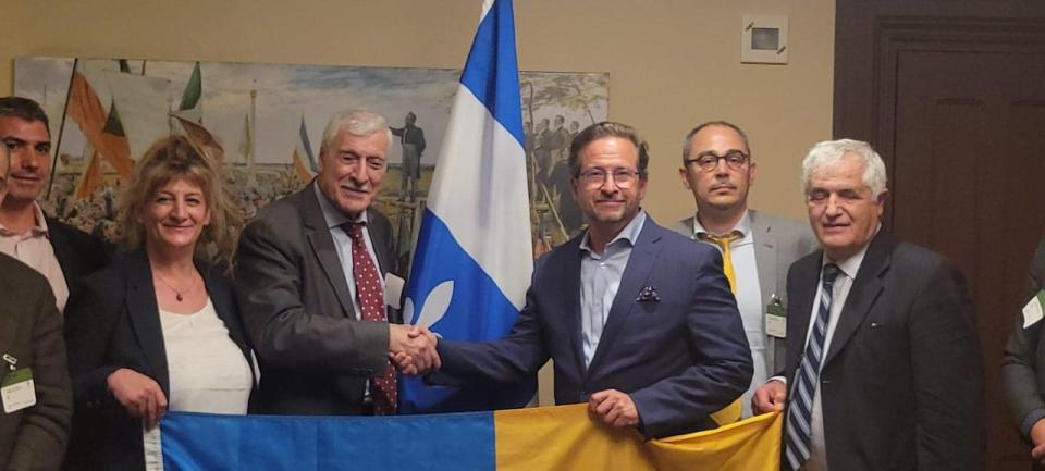 Bloc Québécois Leader Yves-François Blanchet, third from right, shakes hands with the president of the Movement for the Self-Determination of Kabylia (MAK), Ferhat Mehenni, in Montreal in June 2022.