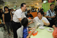 People's Action Party candidate Koh Poh Koon greets residents on a walkabout on Sunday, 13 January. (Yahoo! photo)