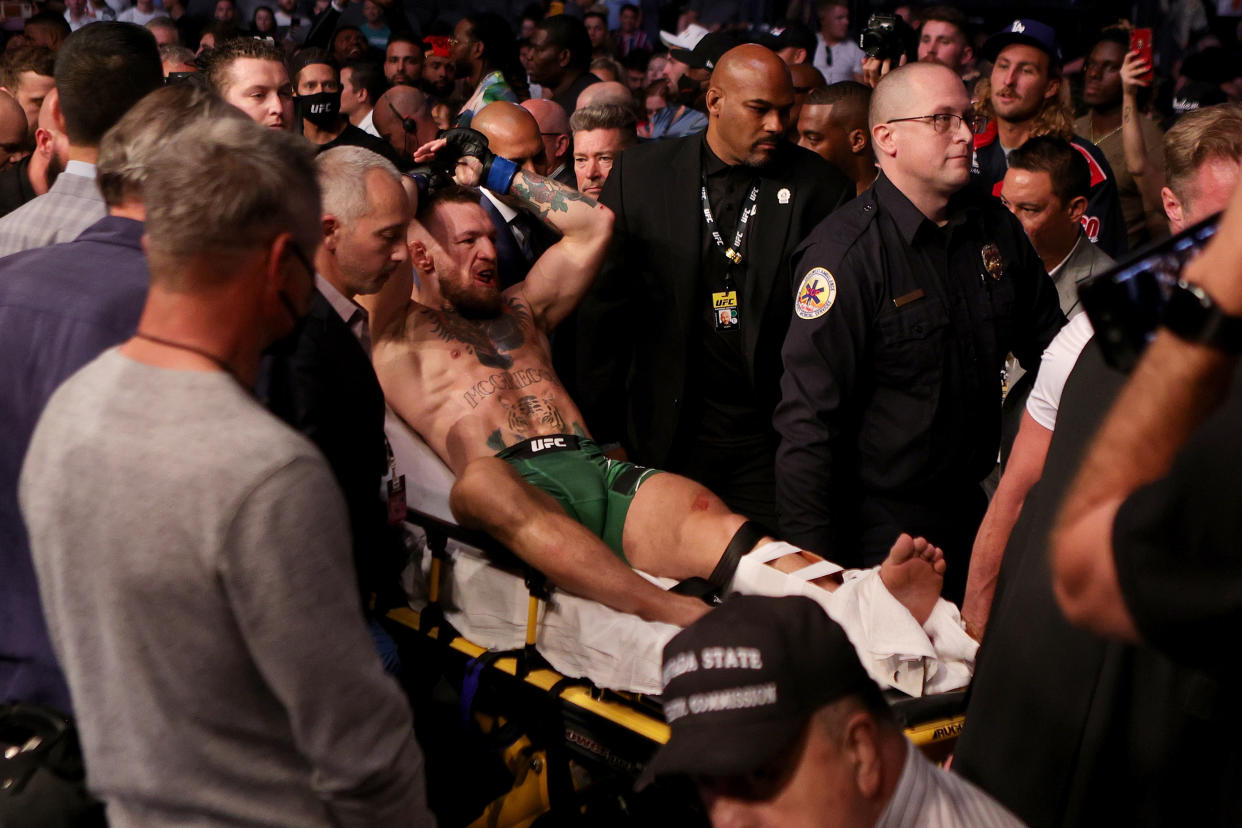 LAS VEGAS, NEVADA - JULY 10: Conor McGregor of Ireland is carried out of the arena on a stretcher after injuring his ankle in the first round of his lightweight bout against Dustin Poirier during UFC 264: Poirier v McGregor 3 at T-Mobile Arena on July 10, 2021 in Las Vegas, Nevada. (Photo by Stacy Revere/Getty Images)