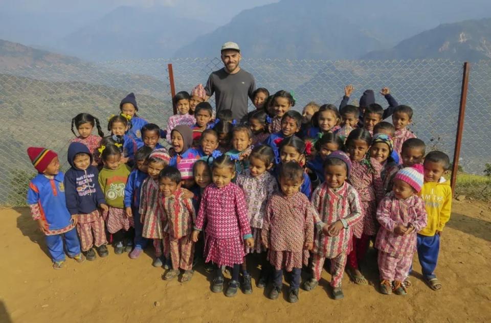 Man with local community children