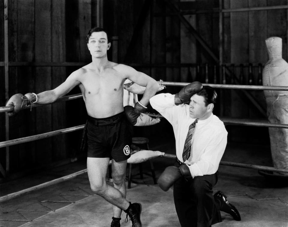 1926: American comedian Buster Keaton (1895-1966) in the boxing ring with a confused looking trainer in his latest film 'Battling Butler'.