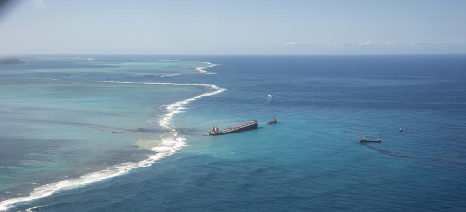 This photo provided by the French Defense Ministry shows oil leaking from the MV Wakashio, a bulk carrier ship that recently ran aground off the southeast coast of Mauritius,, Sunday Aug.9, 2020. The Indian Ocean island of Mauritius has declared a "state of environmental emergency" after the Japanese-owned ship that ran aground offshore days ago began spilling tons of fuel. (Gwendoline Defente/EMAE via AP)