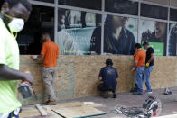 Workers board windows Tuesday, June 2, 2020, in Washington, as demonstrations continue over the death of George Floyd. Floyd died after being restrained by Minneapolis police officers. (AP Photo/Jacquelyn Martin)