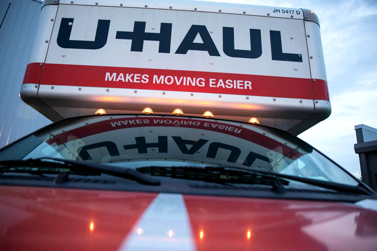 A Uhaul truck is photographed at dusk. 