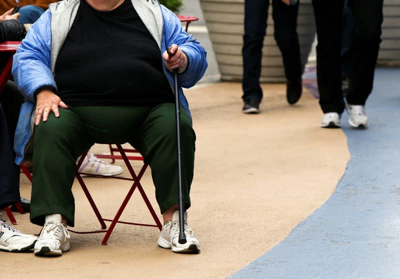 FILE PHOTO: An overweight woman sits on a chair in Times Square in New York