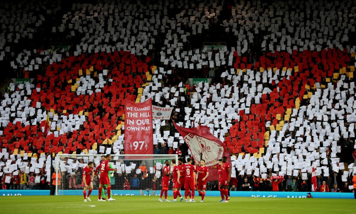 <span>Liverpool fans hold up signs paying tribute to the 97 victims of the Hillsborough disaster.</span><span>Photograph: Phil Noble/Reuters</span>
