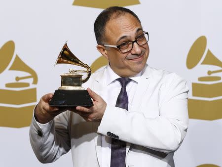 Ashley Kahn poses with his award for best album notes for his work on "Offering: Live At Temple University" backstage at the 57th annual Grammy Awards in Los Angeles, California February 8, 2015. REUTERS/Mike Blake