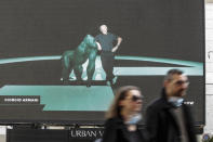 A giant screen streams a Giorgio Armani fashion live show presenting the women's Fall Winter 2021-22 collection, unveiled during the Fashion Week in Milan, Italy, Saturday, Feb. 27, 2021. (AP Photo/Luca Bruno)