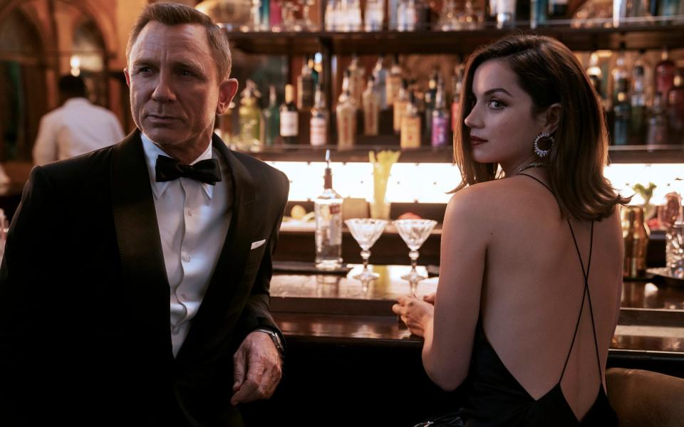 Daniel Craig, left, and Ana de Armas in a scene from "No Time To Die" - Nicola Dove/AP