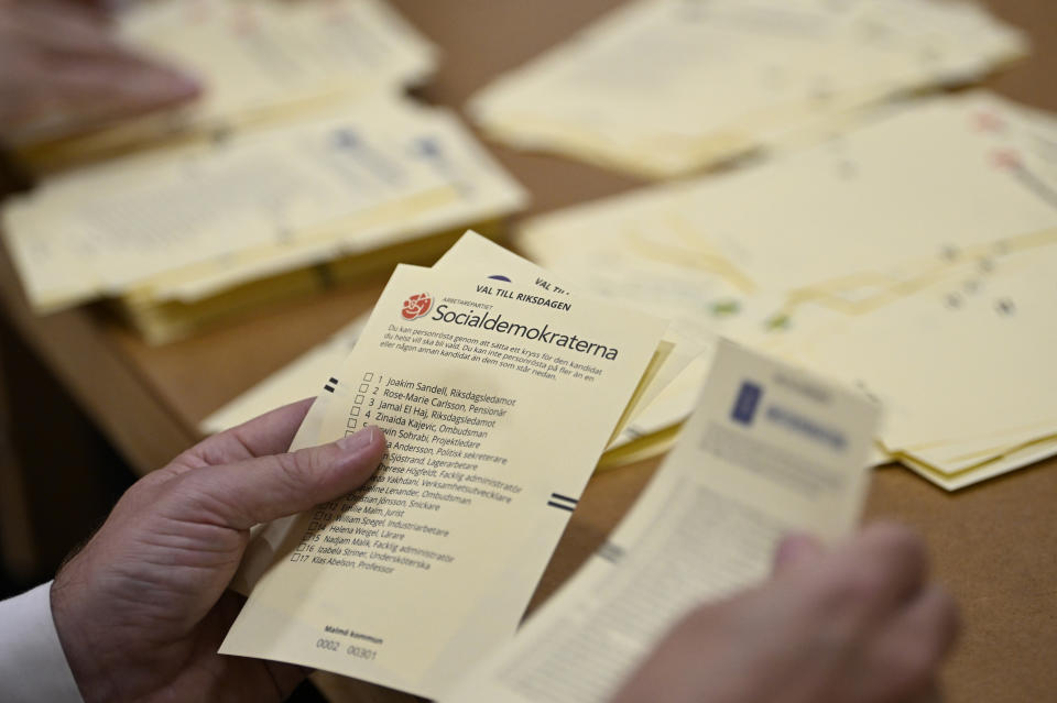 Poll workers count votes at a polling station at Hästhagens Sport Center in Malmö, Sweden, Sunday, Sept. 11, 2022. An exit poll projected that Sweden’s ruling left-wing Social Democrats have won the most votes in a general election Sunday, while a right-wing populist party had its best showing yet. (Johan Nilsson/TT News Agency via AP)