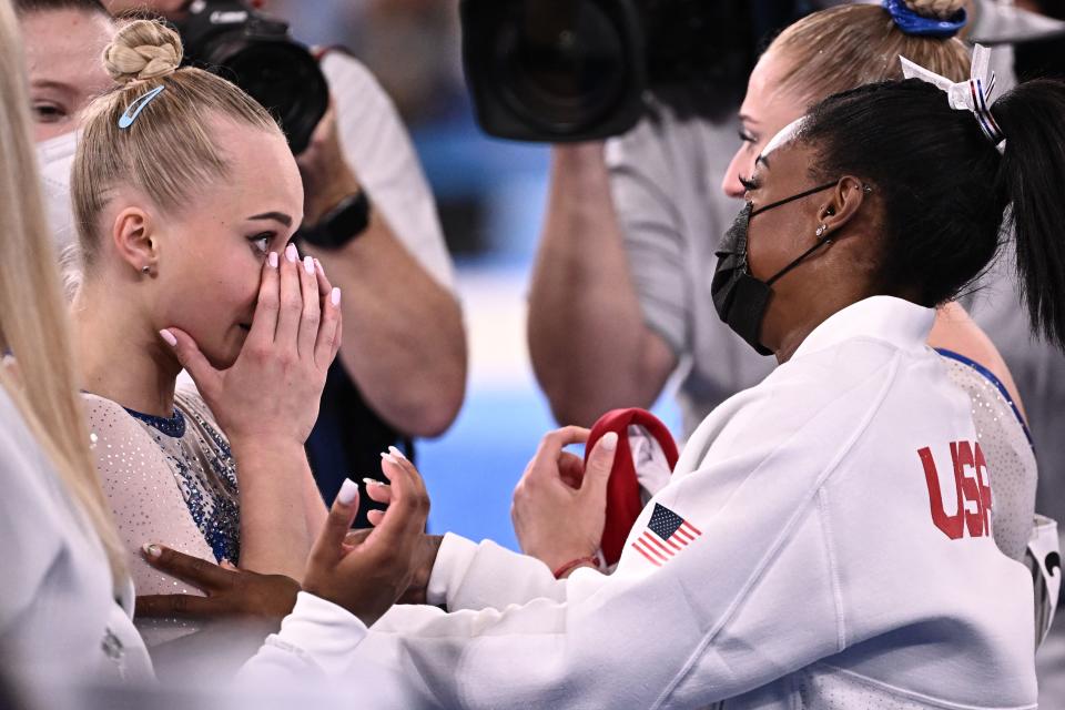 Russia's Angelina Melnikova (L) is congratulated by USA's Simone Biles as Russia wins the artistic gymnastics women's team final during the Tokyo 2020 Olympic Games at the Ariake Gymnastics Centre in Tokyo on July 27, 2021. (Photo by Lionel BONAVENTURE / AFP) (Photo by LIONEL BONAVENTURE/AFP via Getty Images)