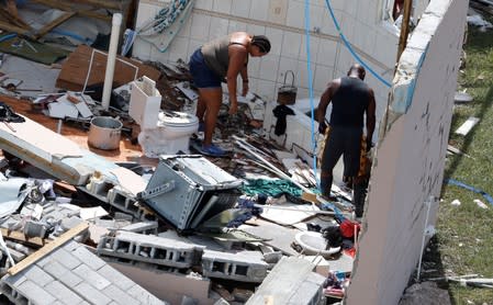 Residents look through debris after hurricane Dorian hit the Grand Bahama Island in the Bahamas