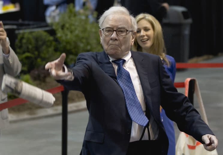 Warren Buffett tosses a newspaper during a competition in Omaha, Neb., Saturday, May 5, 2012. (AP Photo/Nati Harnik)