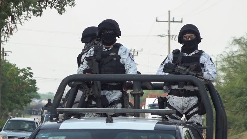 Members of the Mexico's National Guard patrol a road after assailants killed 15 inhabitants of an indigenous village, that has been plagued by local disputes, in San Mateo del Mar