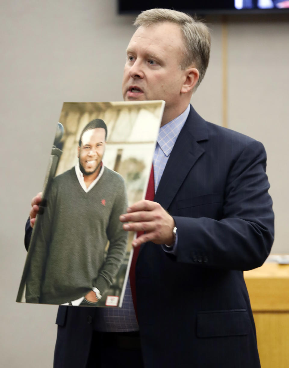 Assistant District Attorney Jason Hermus shows a photo of Botham Jean to the jury during his opening statement before the jury during former Dallas police Officer Amber Guyger''s trial in Dallas, Monday, Sept. 23, 2019. Guyger is accused of shooting Jean, her black neighbor in his Dallas apartment.(Tom Fox/The Dallas Morning News via AP, Pool)