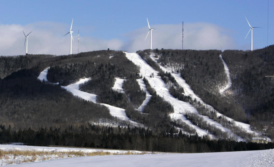 FILE - In this file photo made Jan. 17, 2007, wind turbines stand atop Mars Hills Mountain in Mars Hill, Maine. FirstWind and other wind power companies in Maine are working with snowmobilers' groups to make their sites destinations for winter sledders via 600 miles of trails that are mostly there already. (AP Photo/Robert F. Bukaty, File)