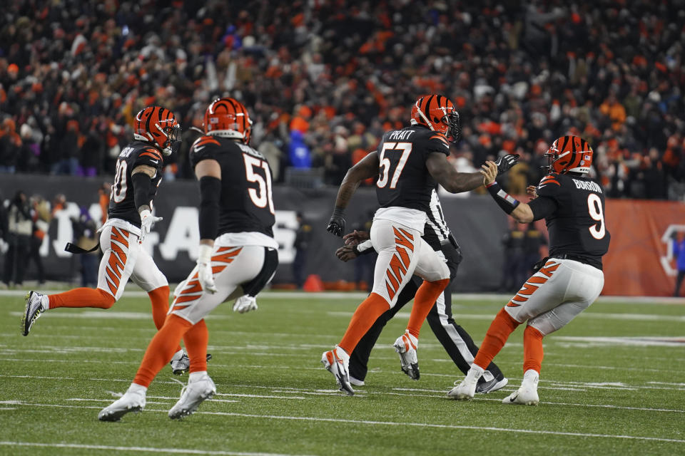 Cincinnati Bengals' Germaine Pratt (57) celebrate with quarterback Joe Burrow (9) after Pratt made an interception during the second half of an NFL wild-card playoff football game against the Las Vegas Raiders, Saturday, Jan. 15, 2022, in Cincinnati. Cincinnati won 26-19. (AP Photo/Jeff Dean)