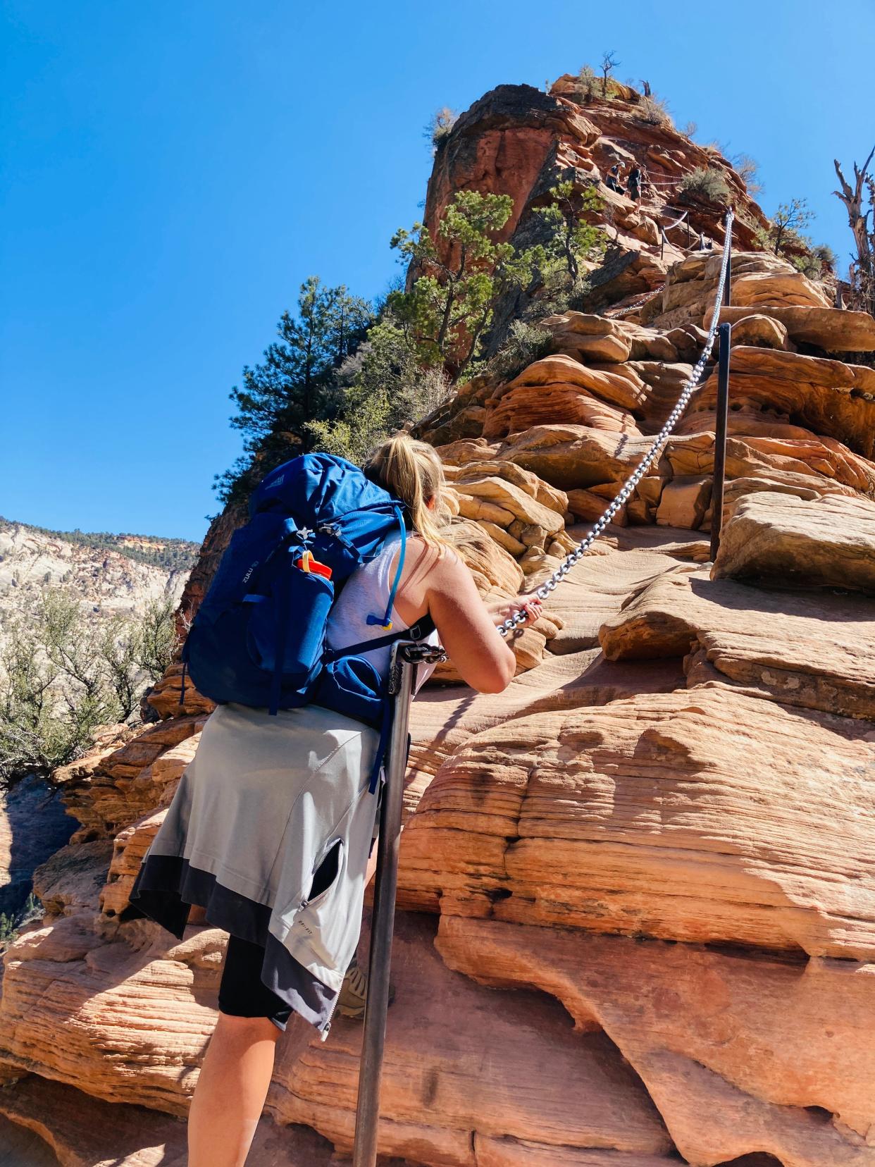 USA Today reporter Amanda Lee Myers uses a chain to hike Angels Landing in Zion National Park on Friday, April 1, 2022