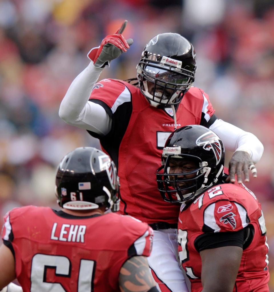 Atlanta Falcons quarterback Michael Vick celebrates a touchdown with offensive tackle Wayne Gandy (72).