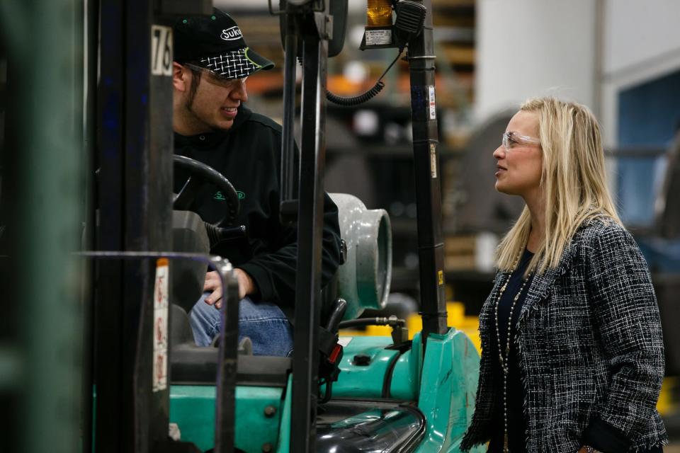 Emily Schmitt, general counsel for Sukup Manufacturing, talks to bender operator Eduardo Orozco at the company's headquarters in Sheffield, Iowa, on Thursday, Dec. 14, 2017.