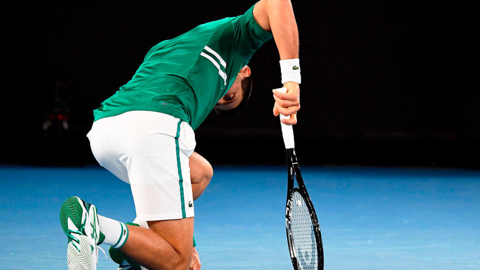 Pictured here, Novak Djokovic goes down on his haunches in agony against Taylor Fritz.