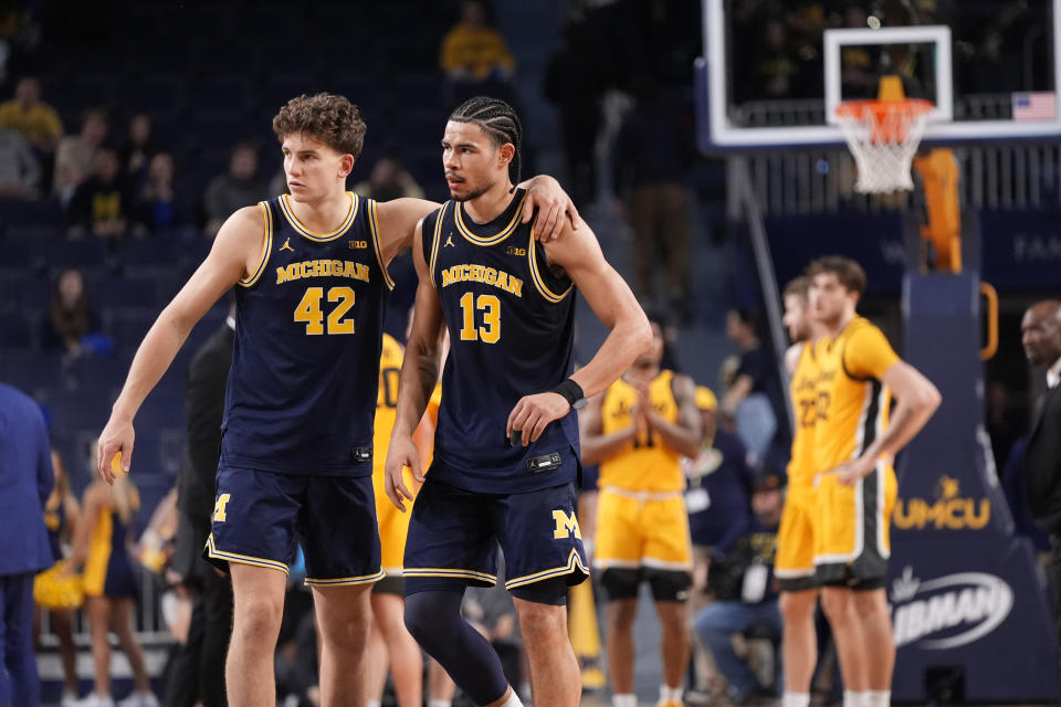Michigan forward Will Tschetter (42) and forward Olivier Nkamhoua (13) walk off the court during the second half of an NCAA college basketball game against Iowa , Saturday, Jan. 27, 2024, in Ann Arbor, Mich. (AP Photo/Carlos Osorio)