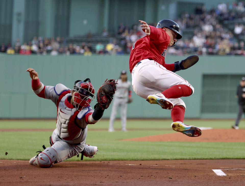 Boston Red Sox's Tyler O'Neill, right, is tagged out at the plate by Washington Nationals catcher Keibert Ruiz during the first inning of a baseball game Friday, May 10, 2024, in Boston. (AP Photo/Mark Stockwell)