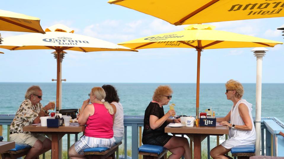 Golden Lion Cafe diners enjoy an oceanfront view from the restaurant's rooftop deck on a recent afternoon. The Golden Lion has been a beachfront fixture for more than three decades in Flagler Beach.