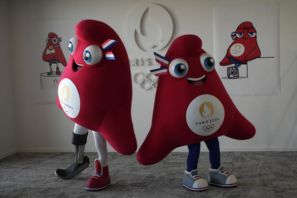 Mascots of the 2024 Paris Olympic Games, right, and Paralympics Games, a Phrygian cap, pose during a preview in Saint Denis, outside Paris, Thursday, Nov. 10, 2022. The soft bright red cap, also known as a liberty cap, is an updated version of a conical hat worn in antiquity in places such as Persia, the Balkans, Thrace, Dacia and Phrygia, where the name originates, in modern day Turkey. It later became a symbol of the pursuit of liberty in the French Revolution and is still worn by the figure of Marianne, the national personification of France since that time. (AP Photo/Christophe Ena)