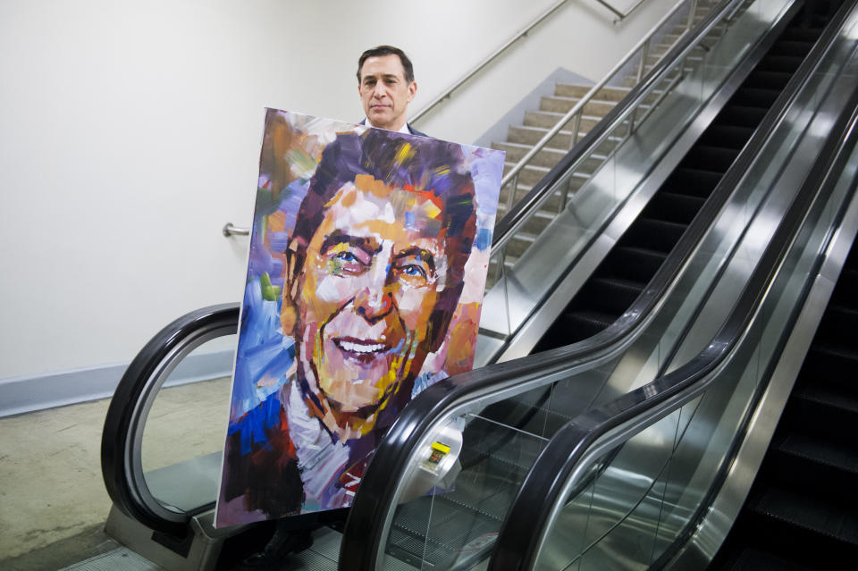 Rep. Darrell Issa (R-Calif.) walks through the basement of the Capitol with a painting of former President Ronald Reagan by artist Steve Penley on Feb. 11, 2015. The painting will be added to Issa's collection of Reagan memorabilia.